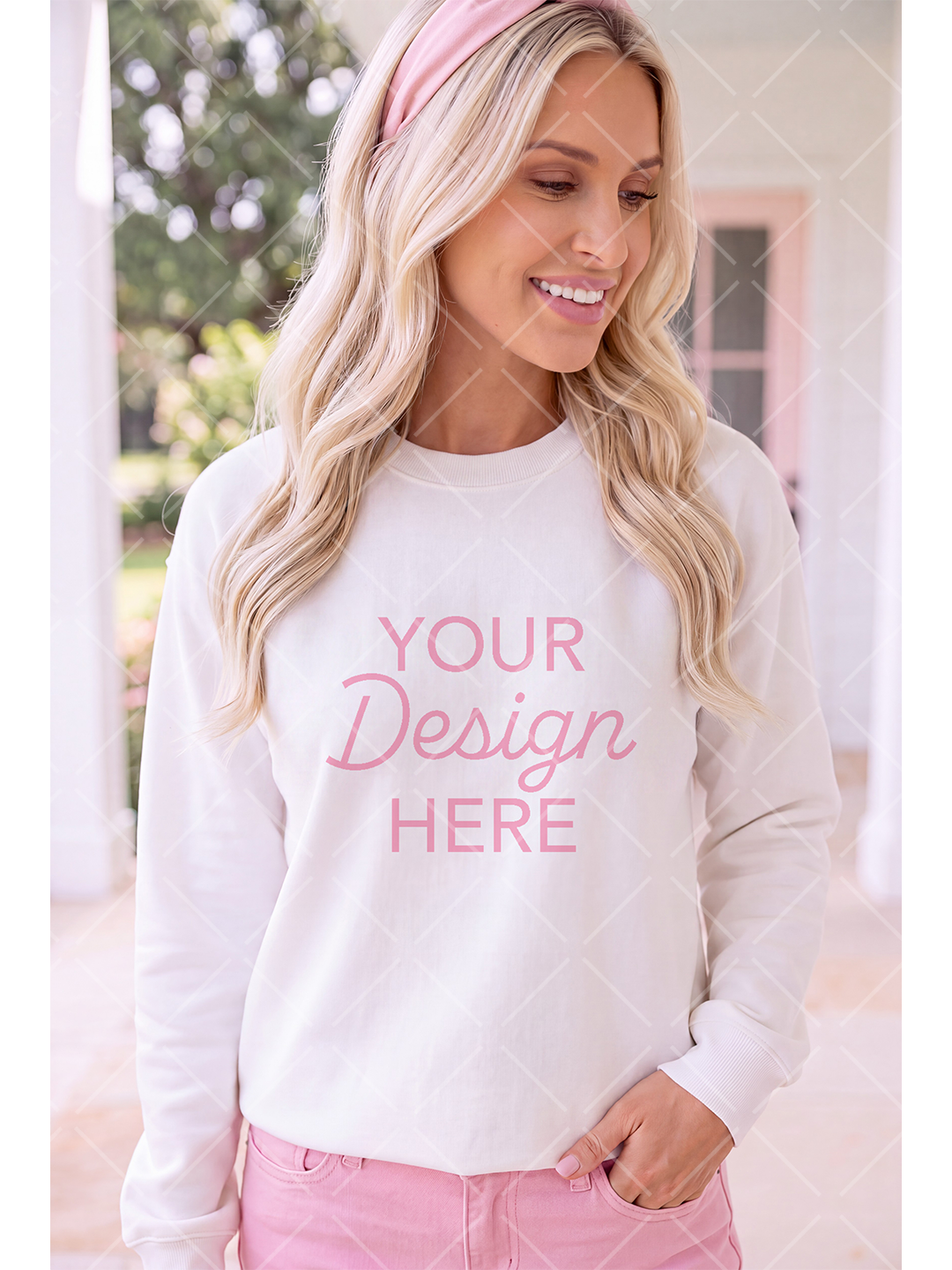 Blonde woman wearing a white crewneck sweatshirt with a pink design placeholder, pink headband, and pink jeans on a bright porch