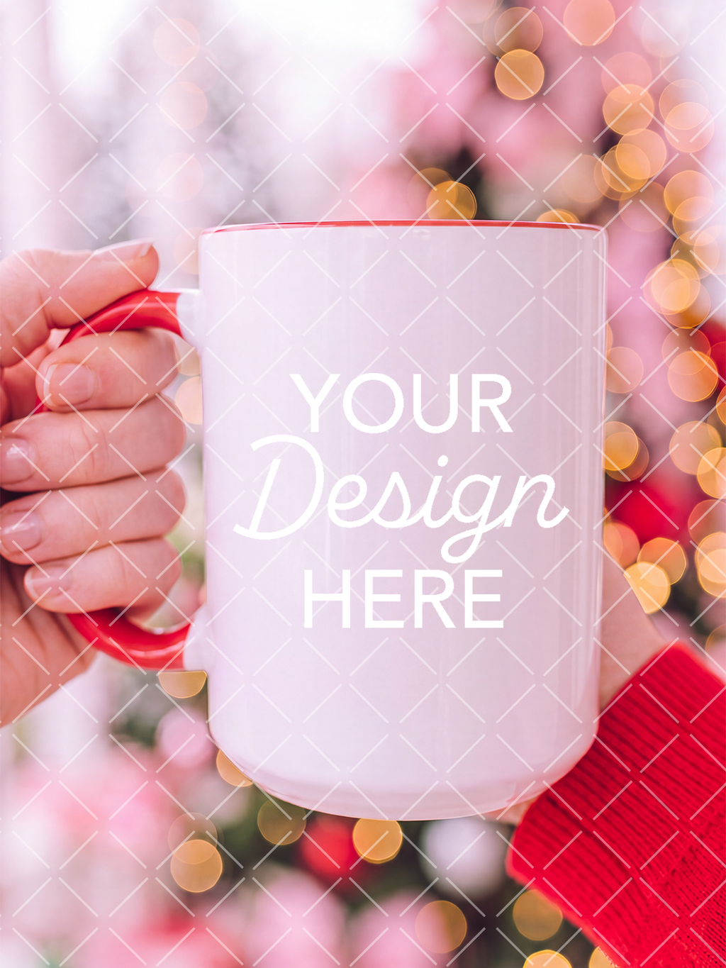 White ceramic mug with a red handle held by a person in a red sweater against softly blurred pink Christmas lights, with a design placeholder on the mug.